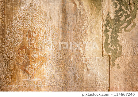 Traditional Apsara dancer stone carving ancient Khmer temple wall bas relief historic art culture mythology religion archaeology detail weathered surface vertical texture Traditional Apsara dancer stone carving ancient Khmer temple wall bas relief historic art culture mythology religion archaeology detail weathered surface vertical texture 134667240