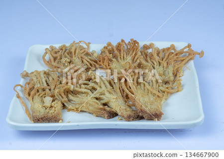 Crispy Fried Enoki Mushrooms on White Ceramic Plate 134667900