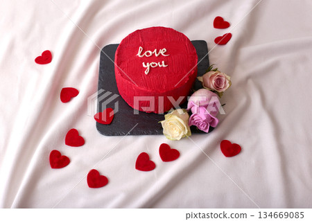 Red heart cake with roses and love message on slate plate for romantic celebration 134669085