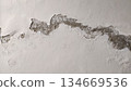 moisture affected wall with peeling and exposed layers 134669536