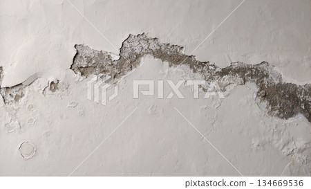 moisture affected wall with peeling and exposed layers 134669536