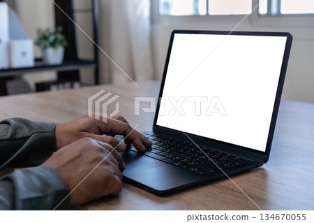 Mockup image of a man using laptop with blank screen on table Mockup laptop computer 134670055