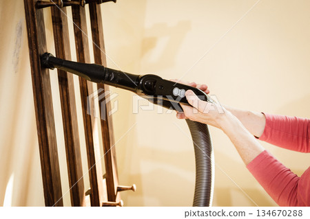 Woman cleaning dust on hanger Woman cleaning dust on hanger 134670288