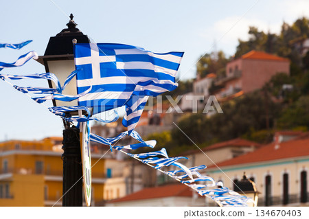 Greek flags waving against city buildings 134670403