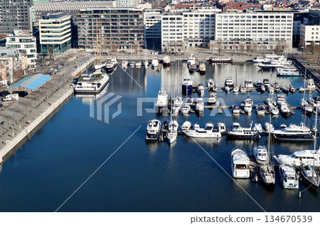 Antwerp city waterfront marina aerial view, boats moored along the docks, historic architecture in background. High quality photo Antwerp city waterfront marina aerial view, boats moored along the docks, historic architecture in background. High quality photo 134670539