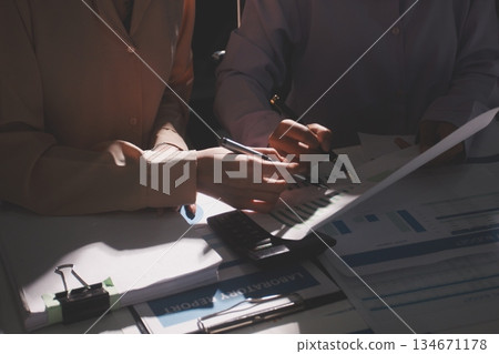 Above table with finance papers, graphs and big data during teamwork meeting with accounting or marketing team discussing budget, strategy or growth development. Closeup of SEO team doing research Above table with finance papers, graphs and big data during teamwork meeting with accounting or marketing team discussing budget, strategy or growth development. Closeup of SEO team doing research 134671178