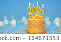 Happy New Year 2026, cute cake with golden ribbon with candle number 2026 for new year celebrate party was lit. blue background with light bokeh, horizontal 134671353