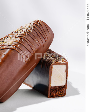 Creamy chocolate-coated dessert on a white background 134671456