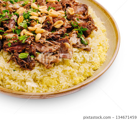 Flavorful dish of spiced rice and tender meat garnished with peanuts Flavorful dish of spiced rice and tender meat garnished with peanuts 134671459