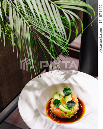 Fresh seafood dish served on a white plate with garnish and greenery 134671462