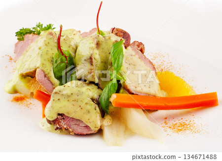 Delicious roasted duck served with creamy sauce and colorful vegetables Delicious roasted duck served with creamy sauce and colorful vegetables 134671488
