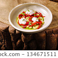 Colorful roasted peppers and creamy cheese on a rustic wooden table 134671511