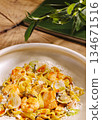 Fresh seafood pasta dish served with herbs and cheese on wooden table 134671516