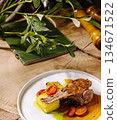 Grilled lamb chop served with vegetables on a rustic wooden table 134671522