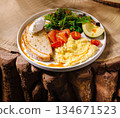 Delicious breakfast plate with eggs, smoked salmon, and fresh greens 134671523