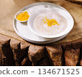 Creamy porridge topped with coconut flakes 134671525