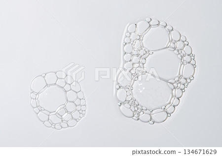 Sample of the foam of shower gel or soap suds or shaving foam. Cosmetic skin care product. Macrophotography. 134671629