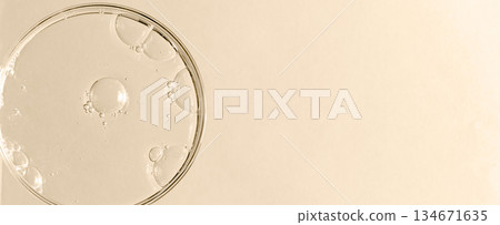 Liquid cosmetic product for the skin in a Petri dish. Copy space Liquid cosmetic product for the skin in a Petri dish. Copy space 134671635