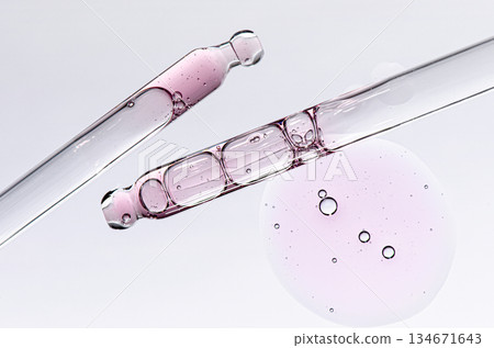 Skin serum in a pipette. A cosmetic product for body care. White background. Skin serum in a pipette. A cosmetic product for body care. White background. 134671643