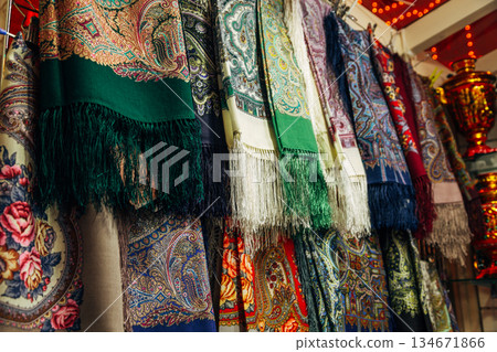 Russian colorful traditional scarfs for sale in a gift shop 134671866