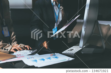 Close up high angle Asian businesswoman working with her coworker in meeting room Close up high angle Asian businesswoman working with her coworker in meeting room 134671921