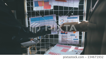 Close up high angle Asian businesswoman working with her coworker in meeting room Close up high angle Asian businesswoman working with her coworker in meeting room 134671932