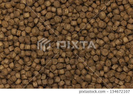 Cat food pellets forming a brown textured background Cat food pellets forming a brown textured background 134672107
