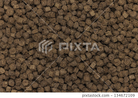 Cat food pellets forming a brown textured background 134672109