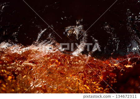 Macro shot of cooling drink with bubbles in motion. Macro shot of cooling drink with bubbles in motion. 134672311