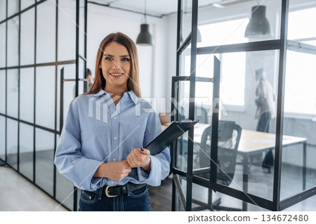 Against her colleagues. Professional workers are in the modern office together Against her colleagues. Professional workers are in the modern office together 134672480