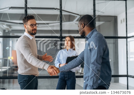 Happy to meet you, handshake. Professional workers are in the modern office together 134673076