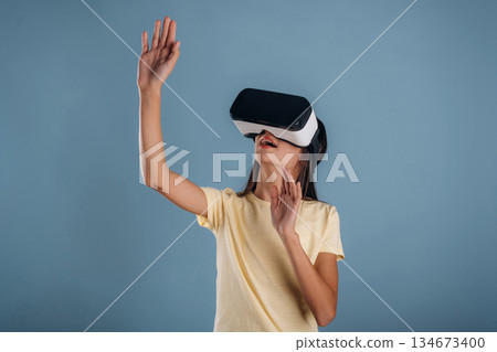 Virtual reality headset. Young girl is against background 134673400