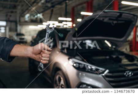 Close up view of mechanic in car service station Close up view of mechanic in car service station 134673670