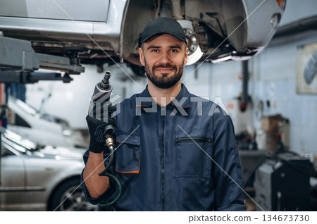 Professional equipment. Mechanic working in a car service station 134673730