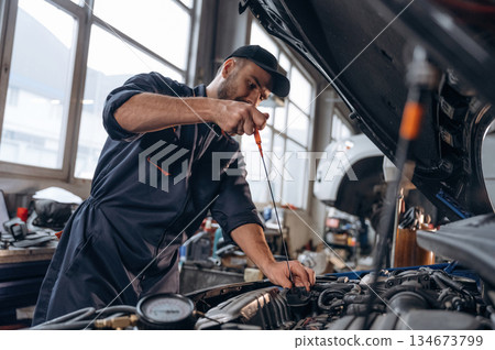 Service station, busy. Mechanic is working Service station, busy. Mechanic is working 134673799
