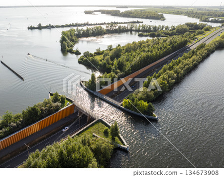 Veluwemeer Aqueduct, road crosses under a waterway in the Netherlands. Innovative intersection of highway and Water Bridge. 134673908