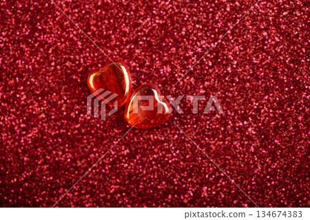 Two Glossy Red Hearts on Glittery Red Background. Valentine's Day Celebration Two Glossy Red Hearts on Glittery Red Background. Valentine's Day Celebration 134674383