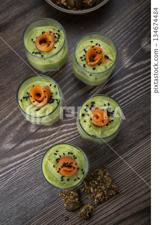 Smoked salmon shot glasses guacamole served with homemade crackers Smoked salmon shot glasses guacamole served with homemade crackers 134674484