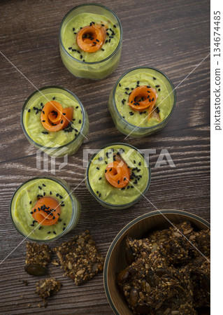 Smoked salmon shot glasses guacamole served with homemade crackers 134674485