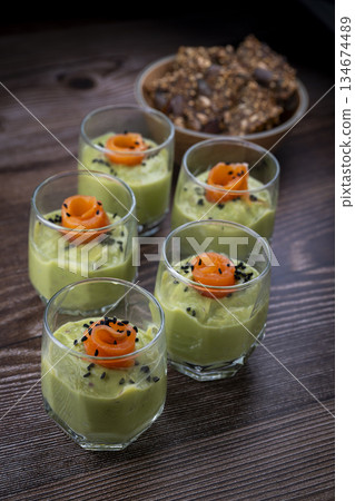 Smoked salmon shot glasses guacamole served with homemade crackers 134674489
