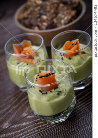 Smoked salmon shot glasses guacamole served with homemade crackers Smoked salmon shot glasses guacamole served with homemade crackers 134674492