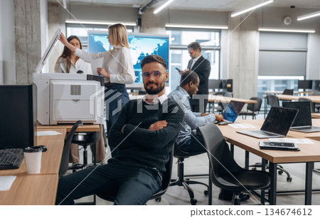 Formal wear. Group of office workers are indoors together Formal wear. Group of office workers are indoors together 134674612