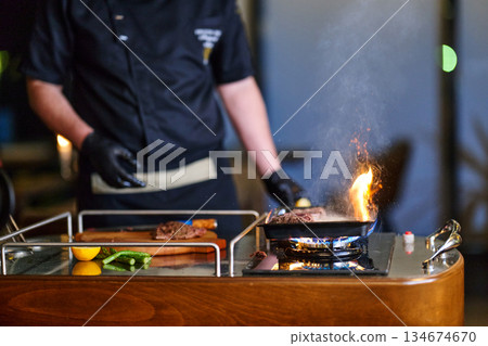 Grilling beef during iftar with family in a cozy setting at sunset in a city restaurant for Ramadan gathering Grilling beef during iftar with family in a cozy setting at sunset in a city restaurant for Ramadan gathering 134674670