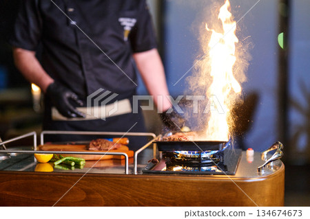 Family gathering during iftar with traditional cooking and vibrant flame in a home setting in Ramadan 134674673