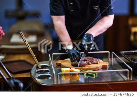 Chef preparing traditional meal for family iftar during Ramadan in cozy dining space with fresh ingredients on wooden board Chef preparing traditional meal for family iftar during Ramadan in cozy dining space with fresh ingredients on wooden board 134674680