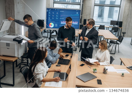 Professional company. Group of office workers are indoors together 134674836