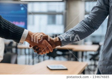Close up view of handshake between two business partners in the office Close up view of handshake between two business partners in the office 134674885
