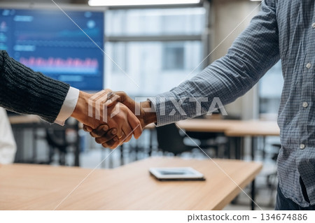 Close up view of handshake between two business partners in the office Close up view of handshake between two business partners in the office 134674886