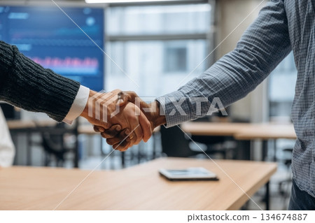 Close up view of handshake between two business partners in the office 134674887
