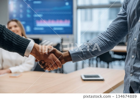 Deal, doing handshake. Group of office workers are indoors together Deal, doing handshake. Group of office workers are indoors together 134674889